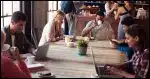 People in a coffee shop all using laptops and presumably Wi-Fi.