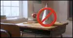 a dunce cap on a desk with a "No" symbol over it