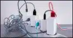 Several USB charging bricks plugged into a power strip.