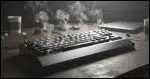 a computer keyboard with smoke coming out of it